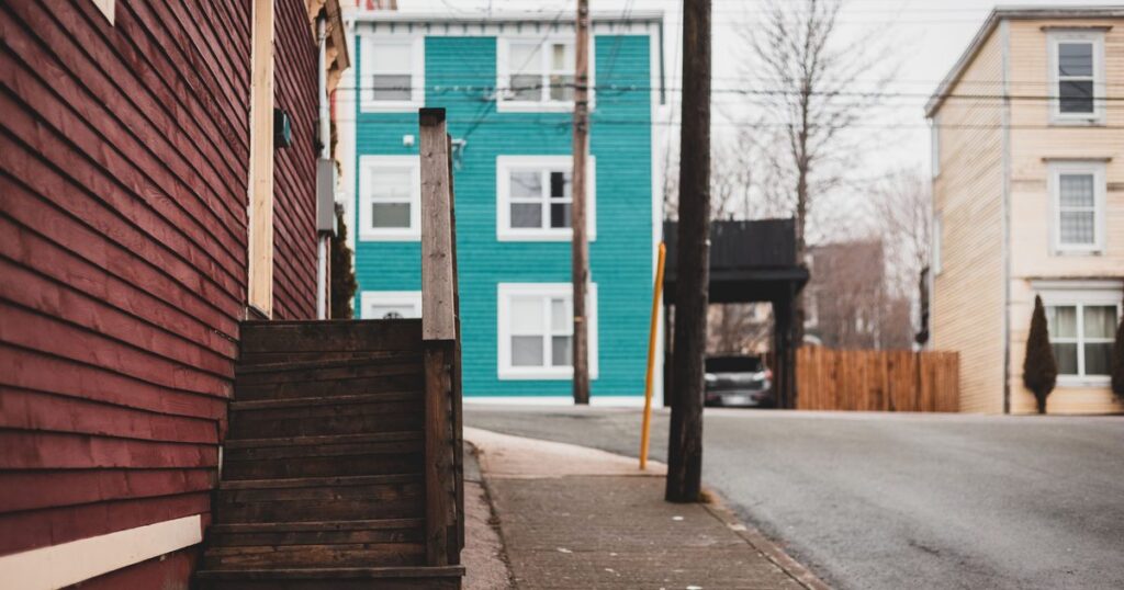 Residential street of houses, where occupancy varies block by block within one city