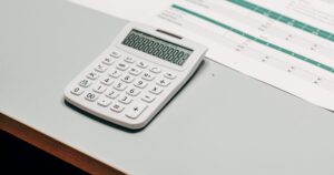 Calculator beside a financial statement, working out whether a lease clears its costs