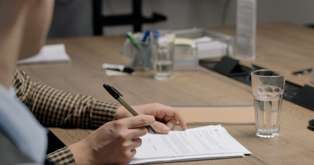 Signing a document at a desk, the written landlord consent arbitrage depends on