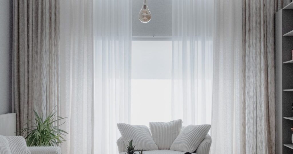Minimalist living room with sheer curtains and daylight in a short-term rental