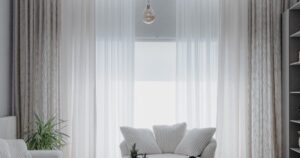 Minimalist living room with sheer curtains and daylight in a short-term rental