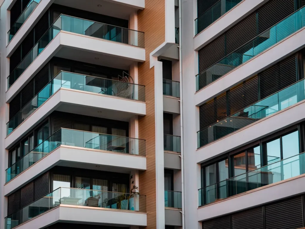 The glass balconies of a contemporary apartment building seen from below