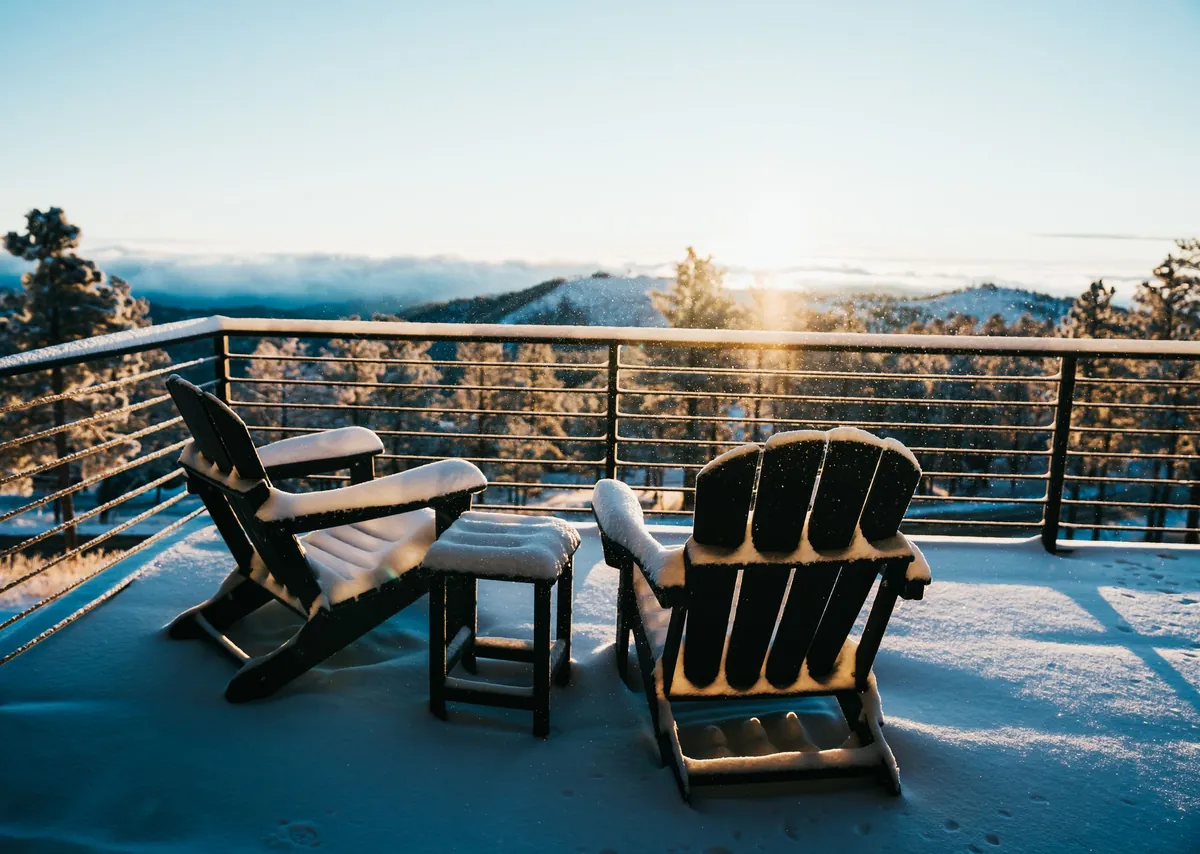 Empty wooden deck chairs on a terrace at sunset