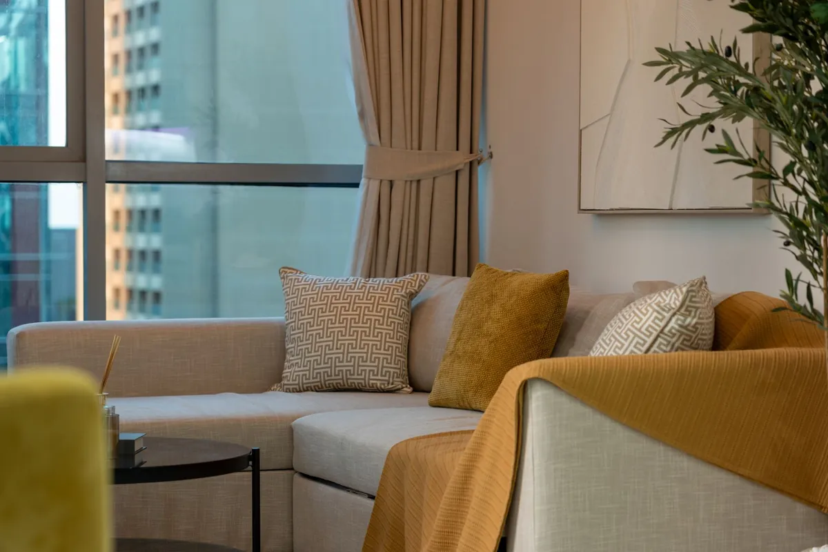An elegant modern living room with a low sofa and soft evening light
