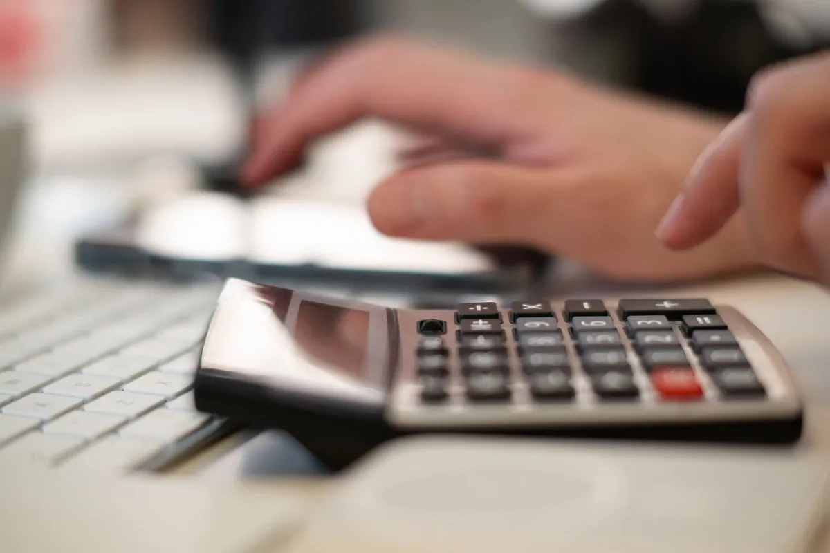 A desk calculator and a keyboard photographed close up