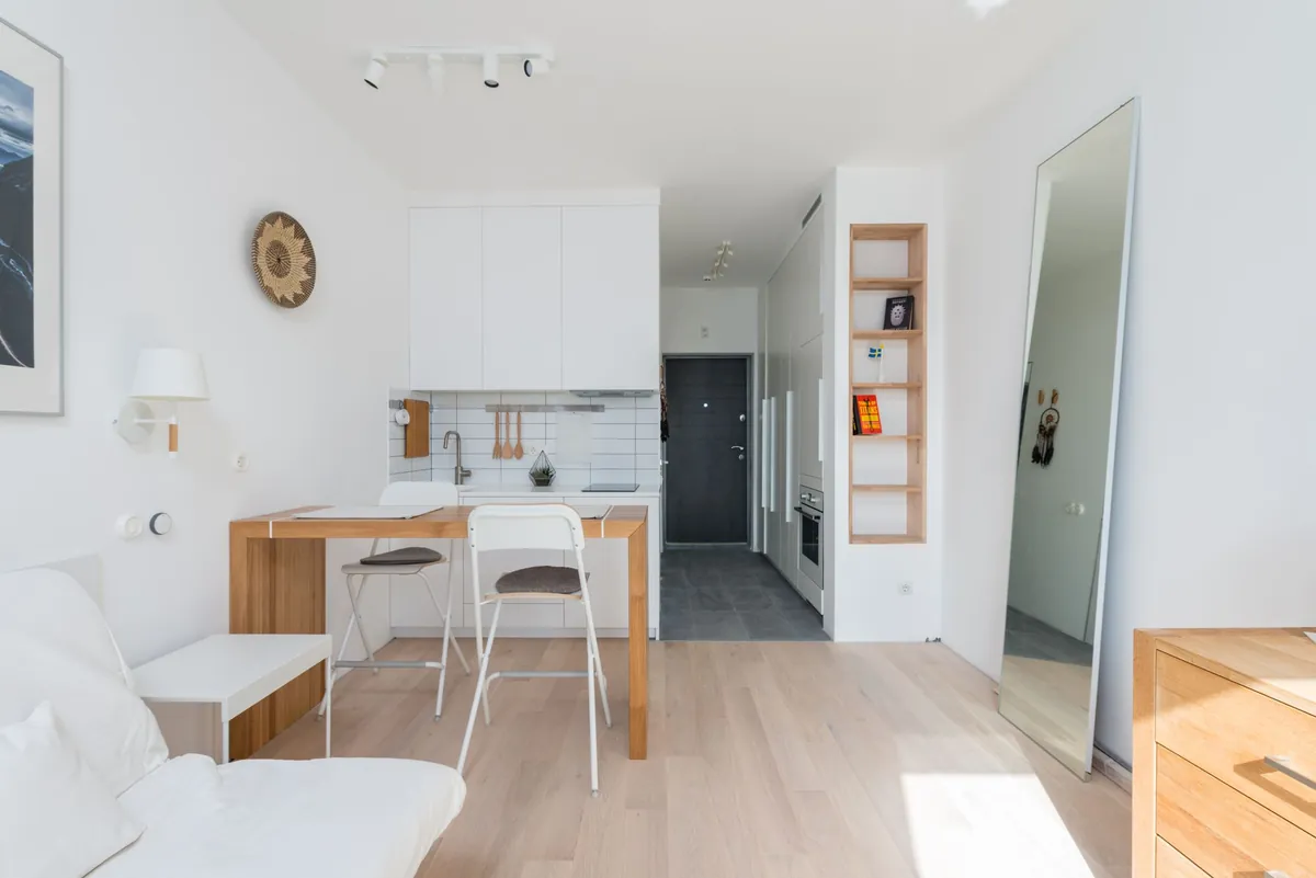 The interior of a light modern apartment with a comfortable couch