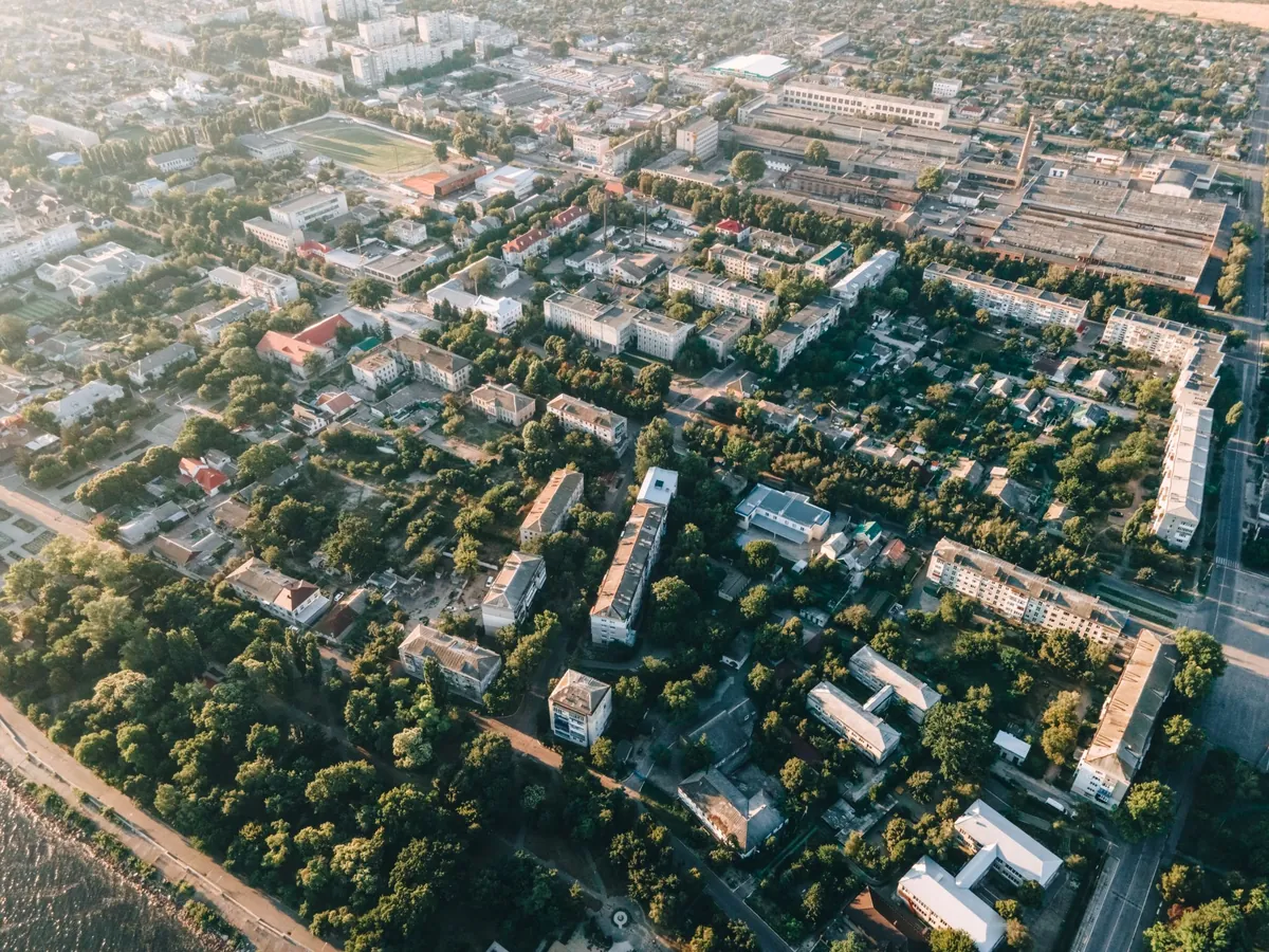 An aerial view of a leafy residential district with detached houses and streets