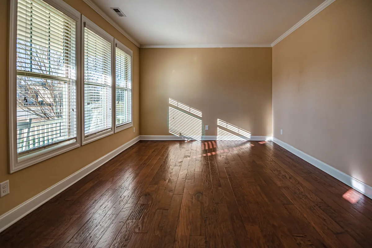 An entirely empty room with bare walls and a window