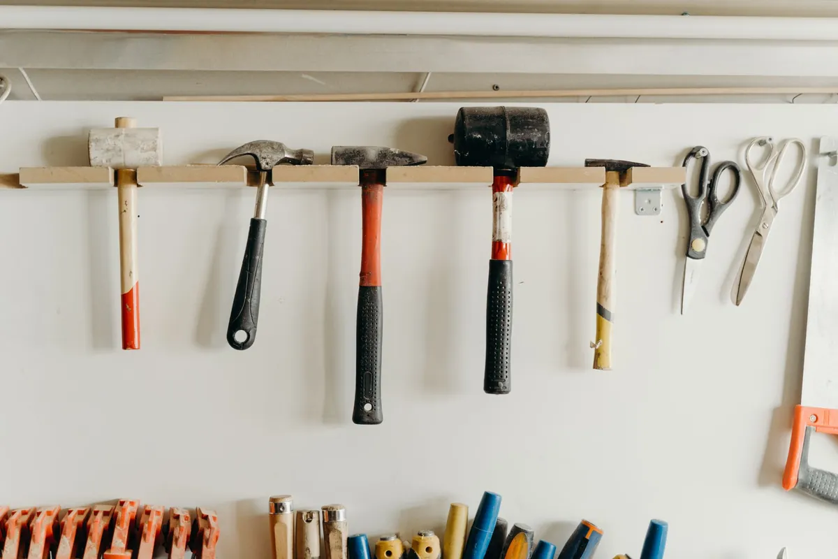 Hand tools hanging in neat rows on a workshop wall