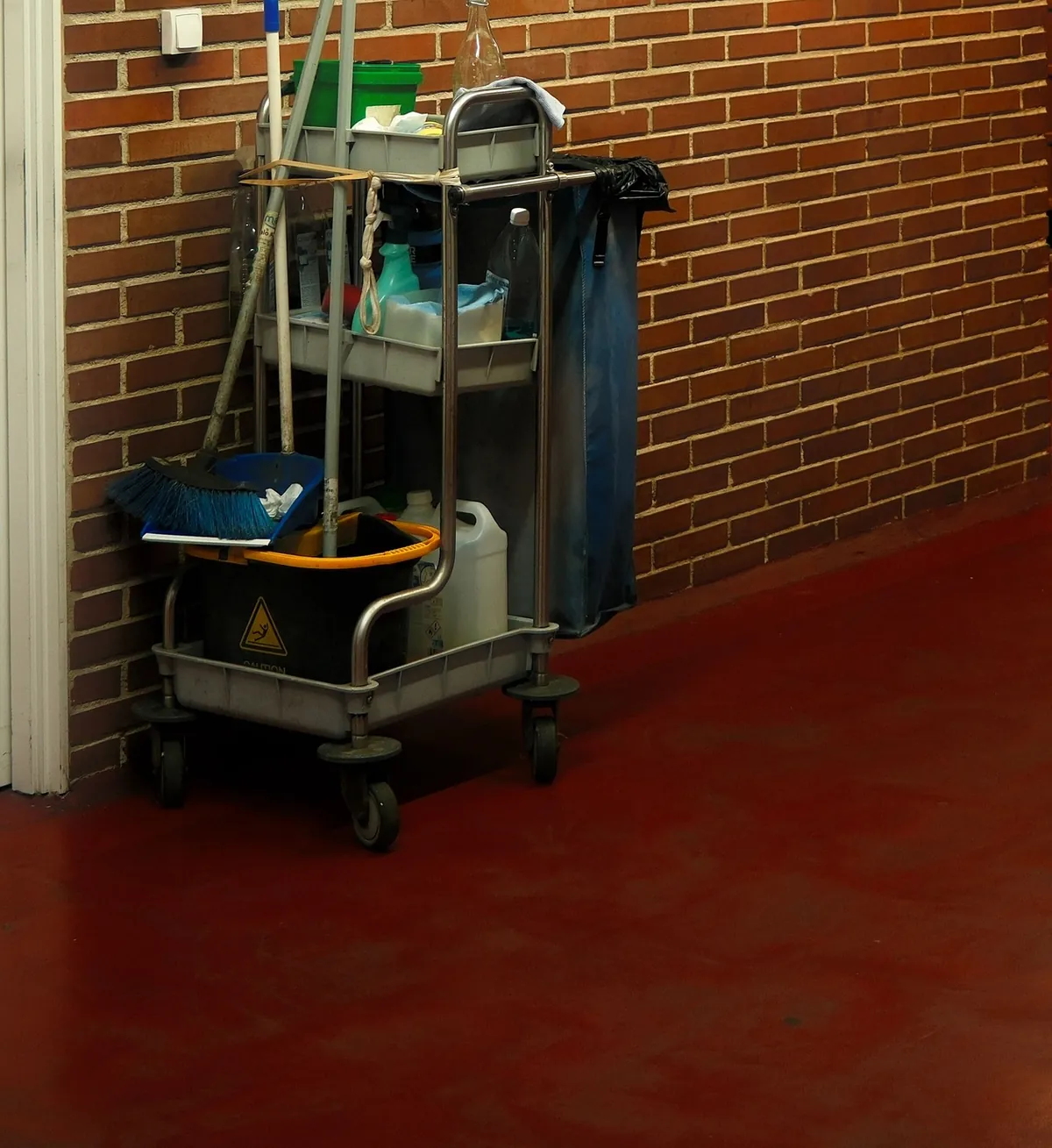 A housekeeping cart standing in a corridor between jobs