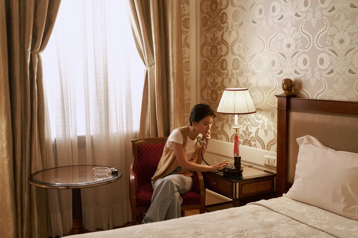 A guest making a call from a room telephone