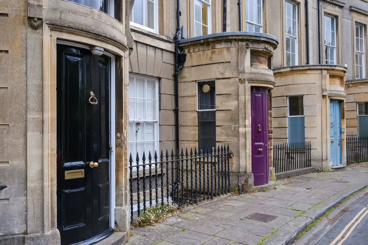 A row of Georgian front doors painted black, purple and blue