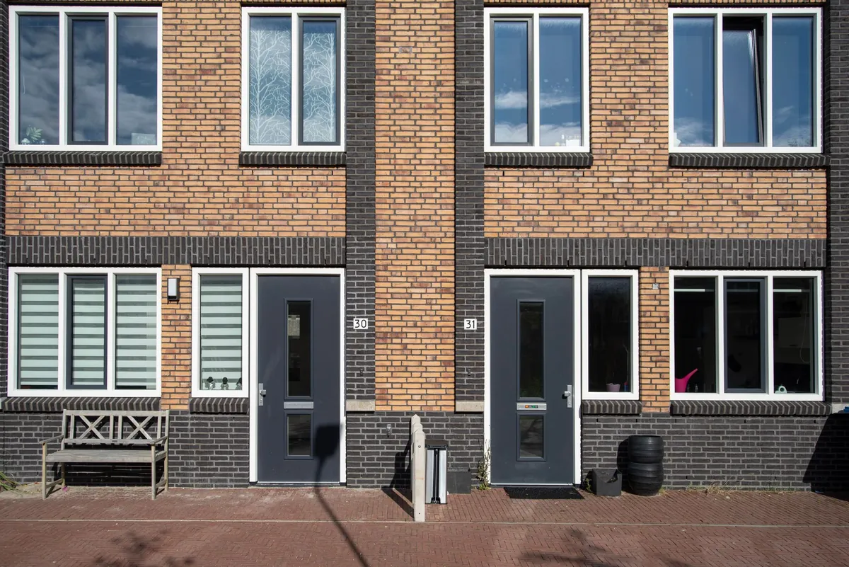 Two identical front doors side by side on one building, numbered 30 and 31