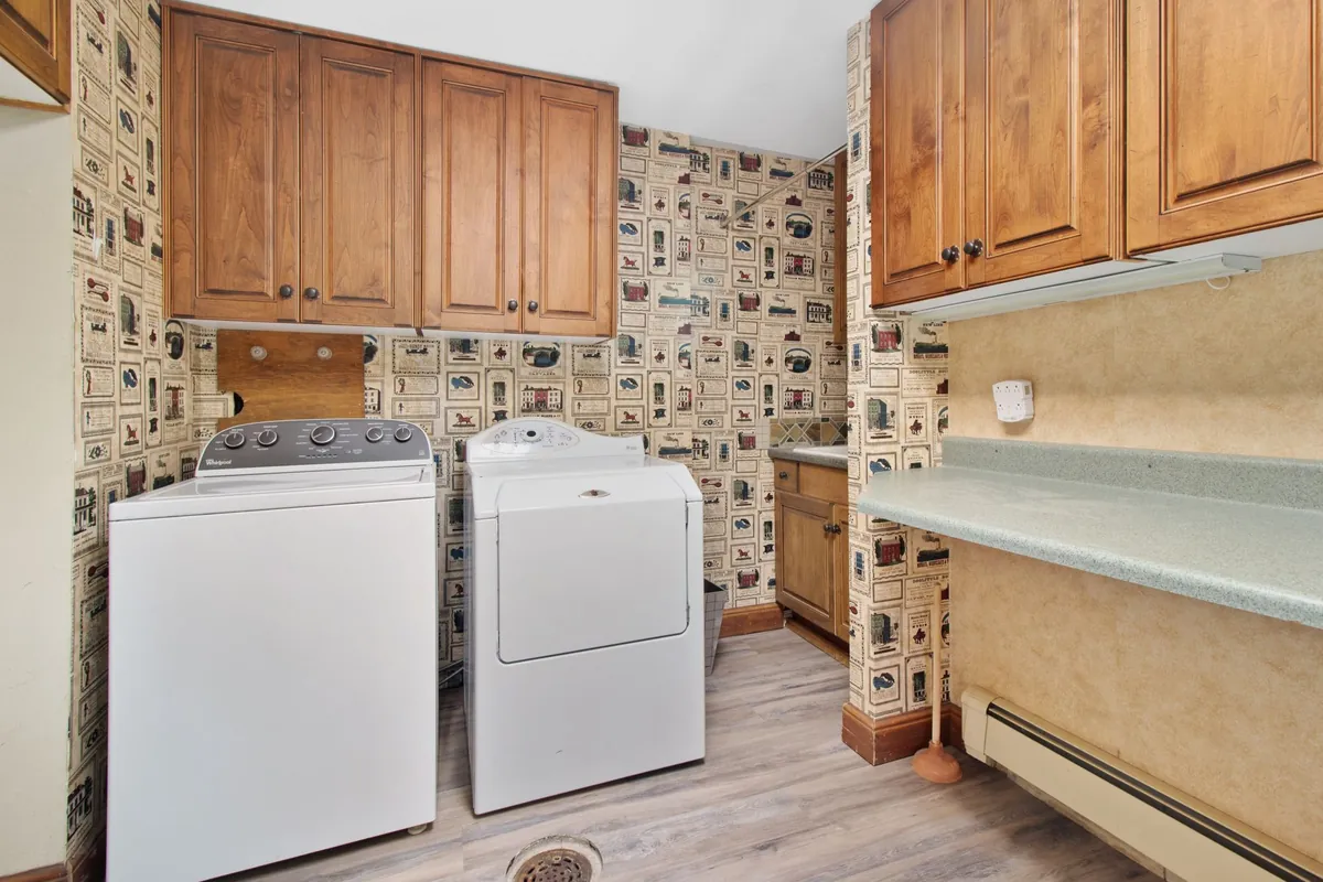 Laundry room with a washer and dryer standing side by side.
