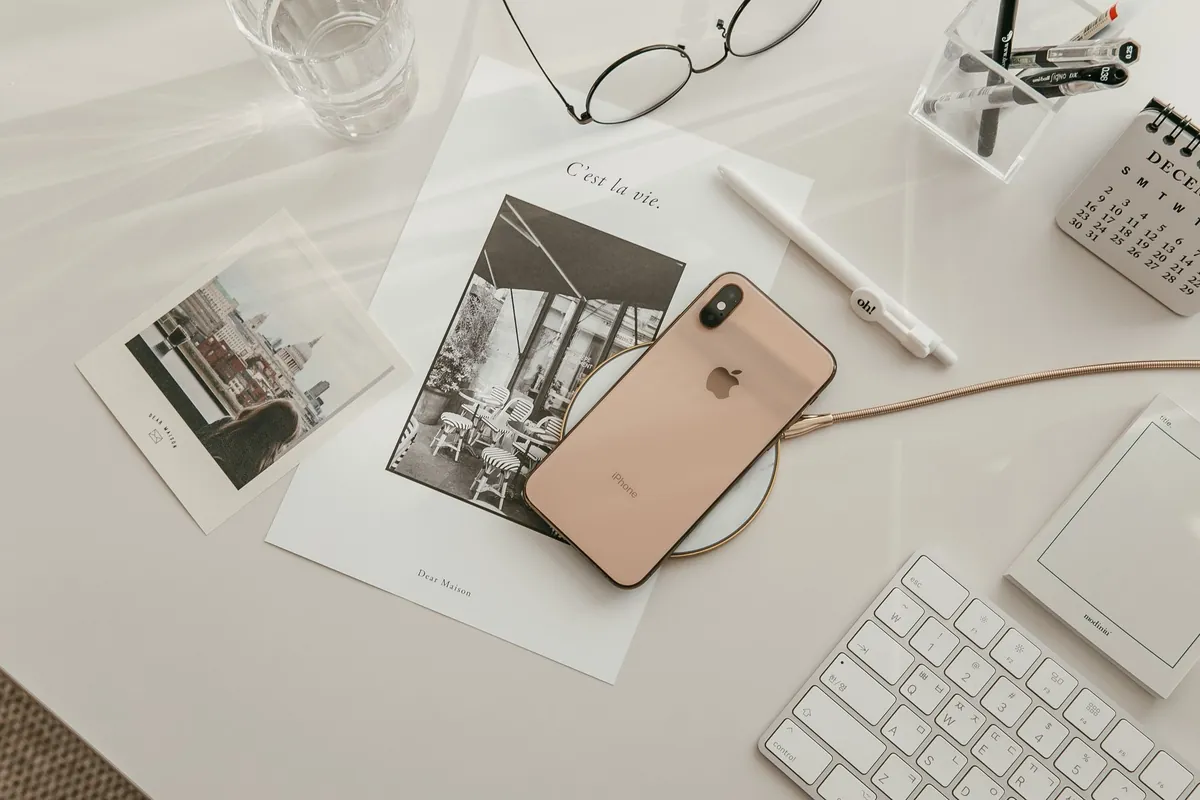 Desk with smartphone, keyboard, pen and notepad
