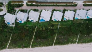 Aerial view of beachfront homes with pools along the coast in Fort Pierce, Florida