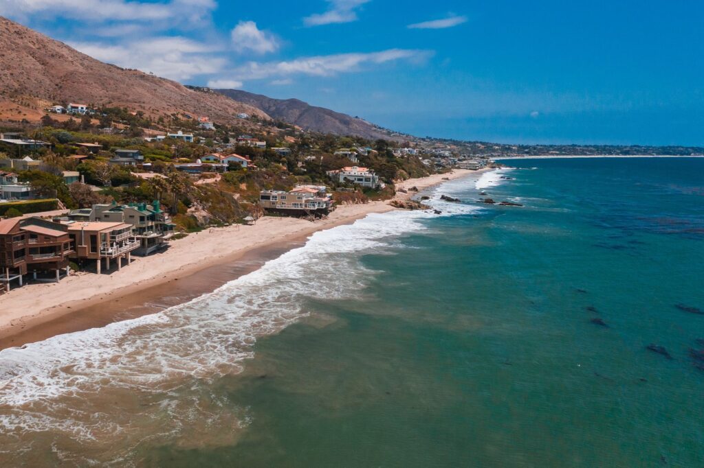 Aerial view of beachfront homes along a Pacific coastline