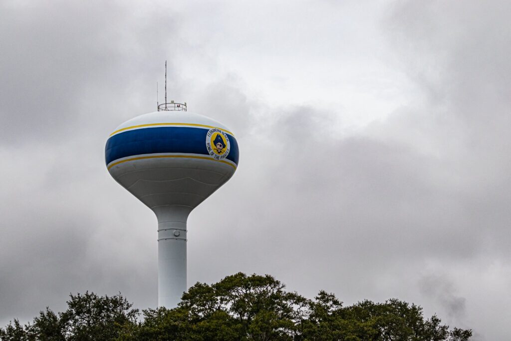 Tall water tower against a dramatic cloudy sky in a Florida beach town