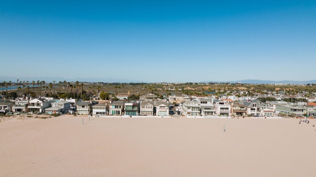 Aerial view of beachfront houses along the Newport Beach coastline