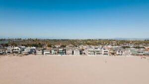 Aerial view of beachfront houses along the Newport Beach coastline