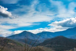 Mountain landscape with forested ridges under a clear blue sky