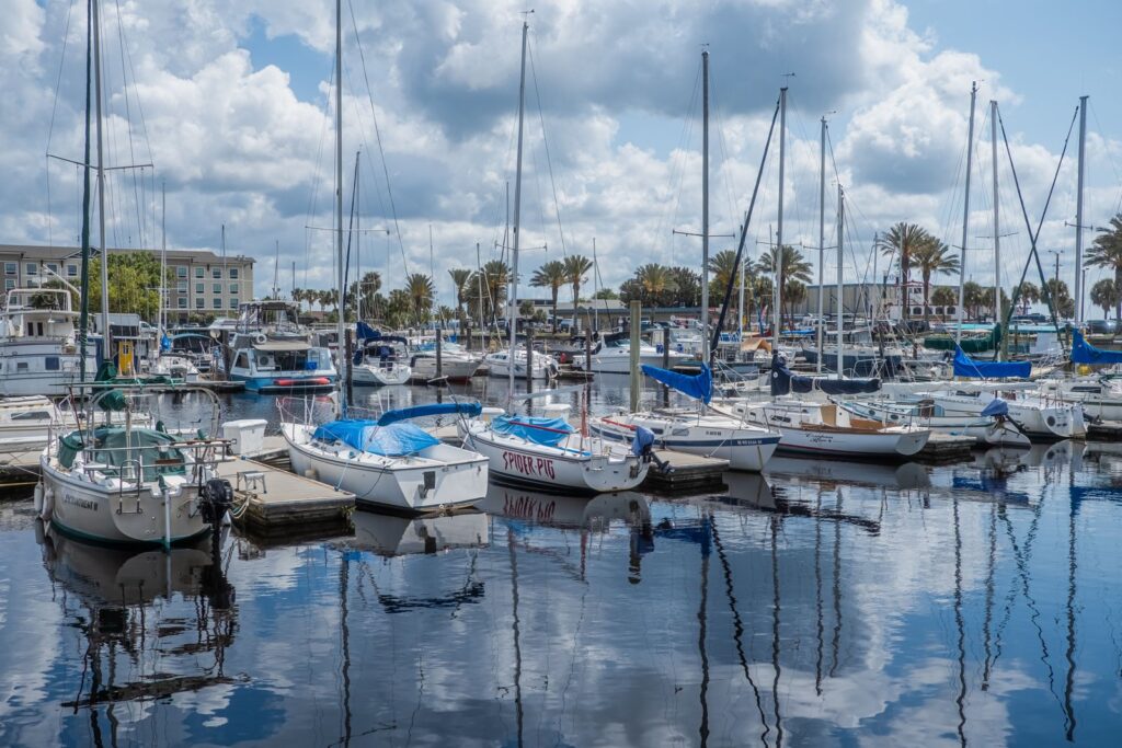 Marina filled with sailboats and yachts under a cloudy sky